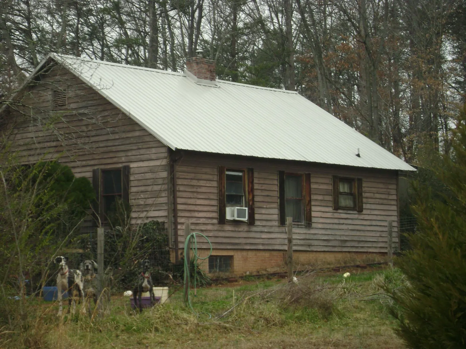 White metal roof on an old wood sided farmhouse, from a Metal Roof Installation job in West Alexander